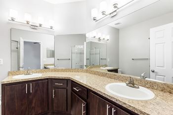 a bathroom with two sinks and a large mirror